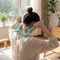 Six-wheel manual massage roller in use on neck and back
